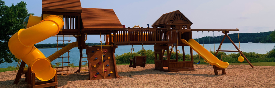Brand new playground at Coppermine Lodge with Beaver Lake backdrop
